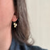 14k gold-filled shamrock earrings as shown on model