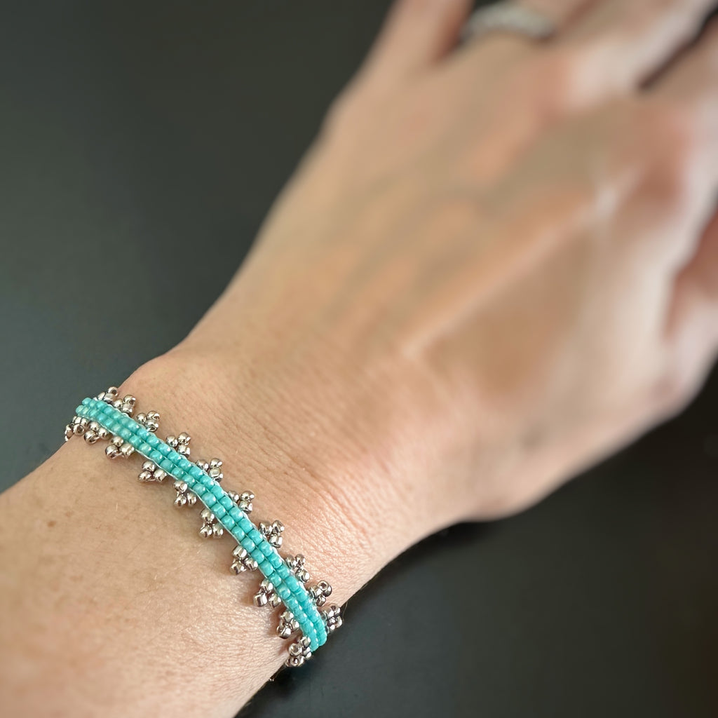 Turquoise hand stitched beaded bracelet with silver accent.